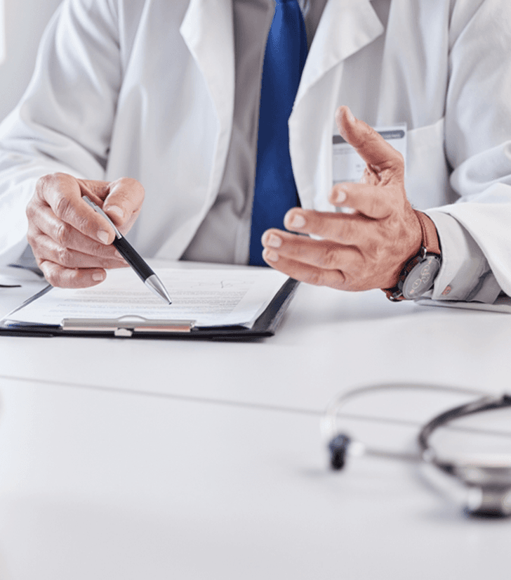 Physician reviewing paperwork at a desk